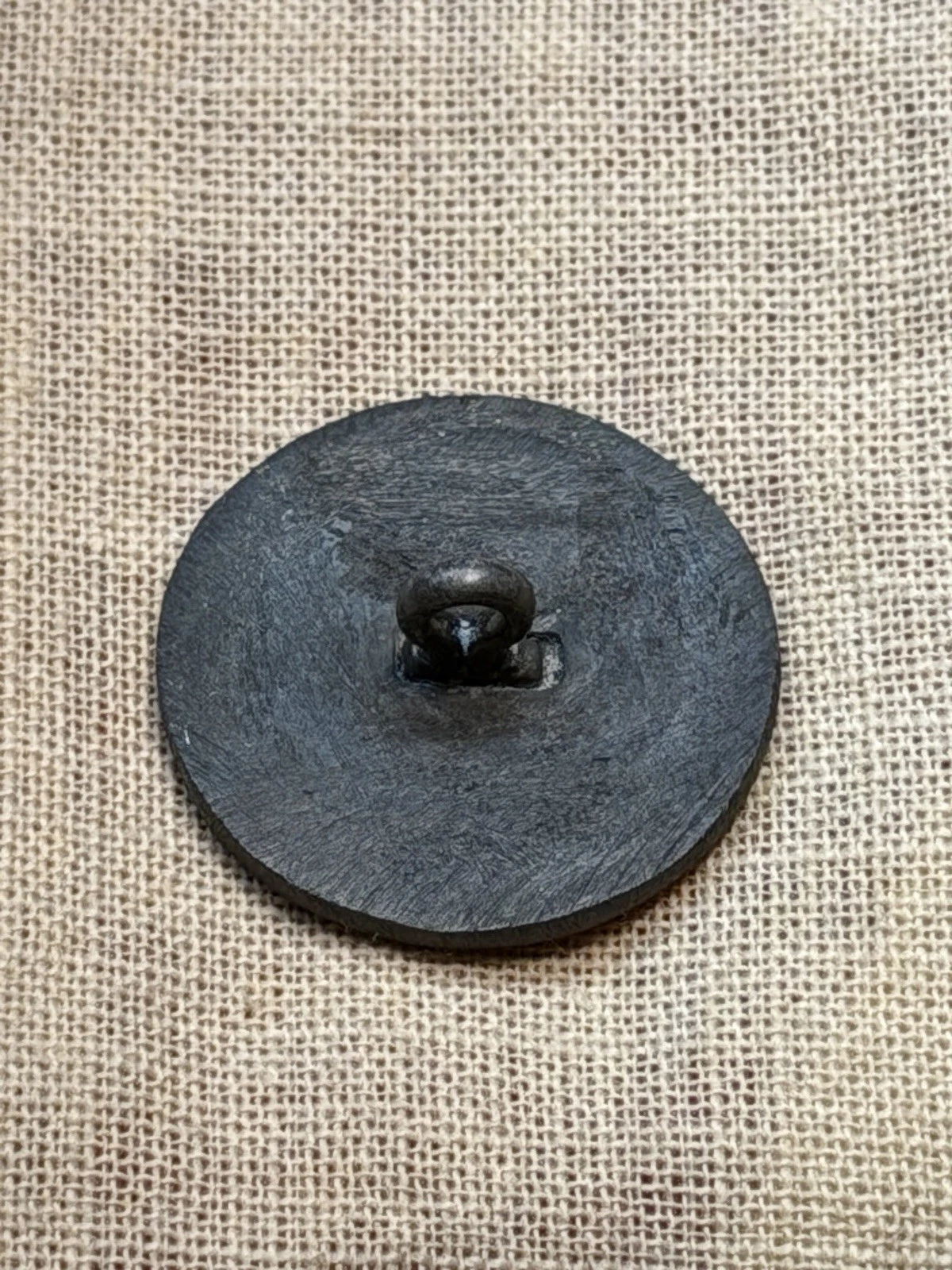 Small-size button side view revealing questionable patina